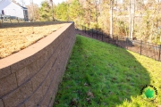 Side-view-retaining-wall-fence-Evans-backyard-landscaping-Between-the-Edges
