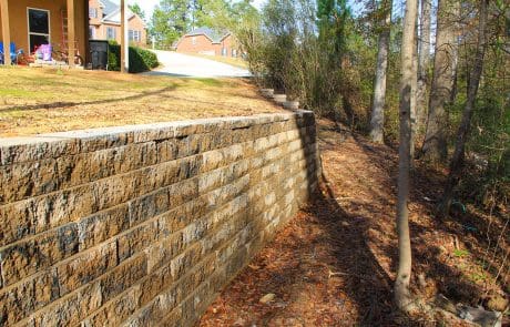 Sloped backyard retaining wall installation in Martinez, GA